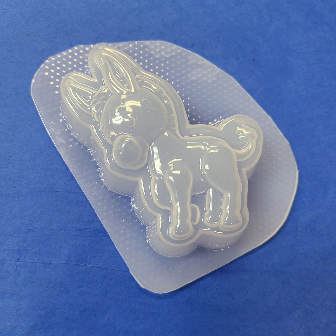 Clear plastic donkey mold, a standing burro seen side-on