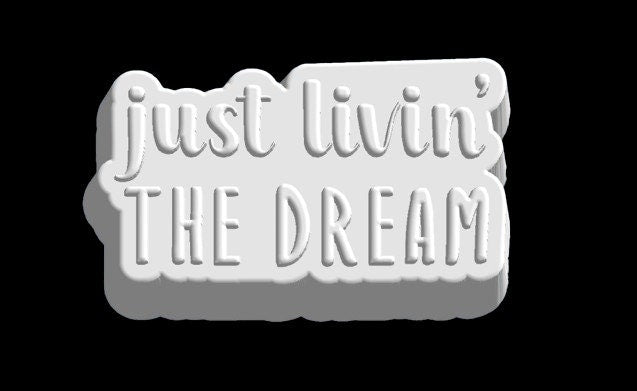 Grey render of the just livin' THE DREAM plaque mold, script over block capitals.
