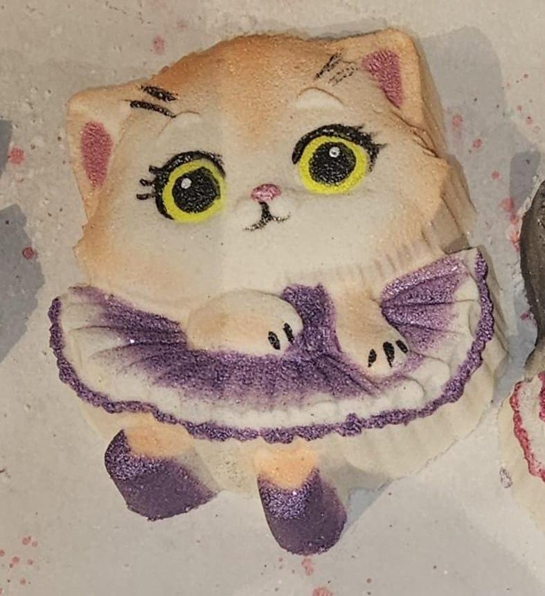 Ginger and cream ballerina kitten cast with yellow eyes and a purple and white tutu.