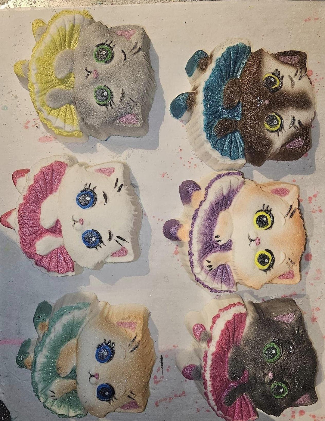 Six ballerina kitten casts painted differently, tutus in yellow, blue, pink and teal.