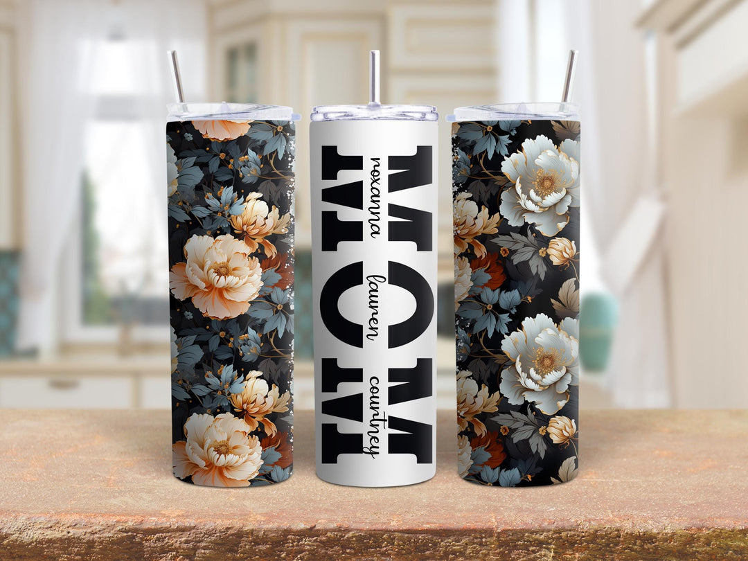 Three 20oz tumblers on a counter: two in dark peony wrap, one with MOM and names in script.