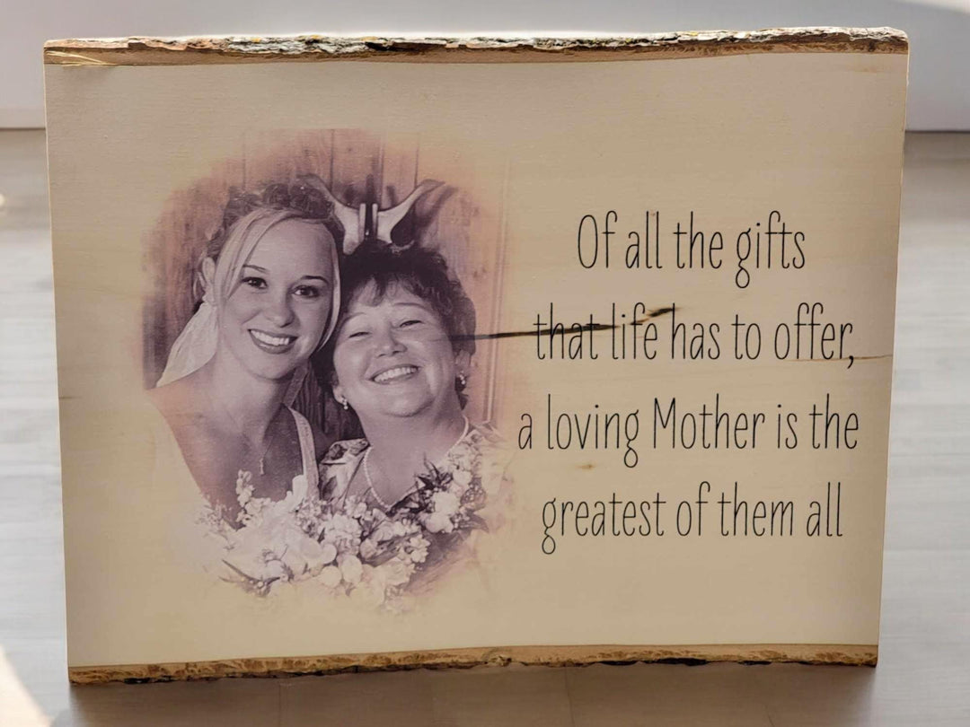 Wood slab printed with a mother and daughter photo and a quote, bark left along the top edge.