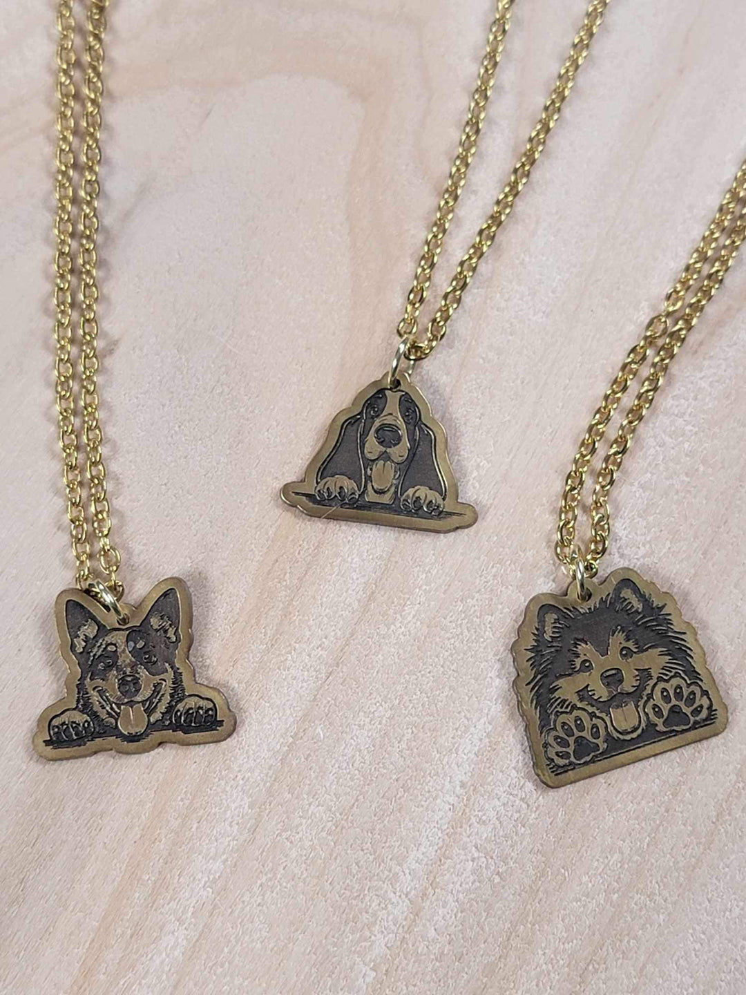 Engraved brass dog pendant necklace on a stainless steel chain