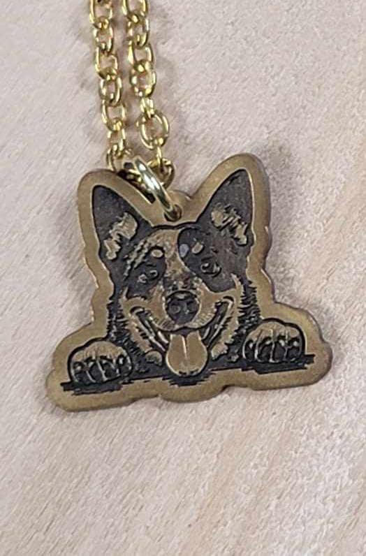 Engraved brass dog pendant necklace, close view of the engraving