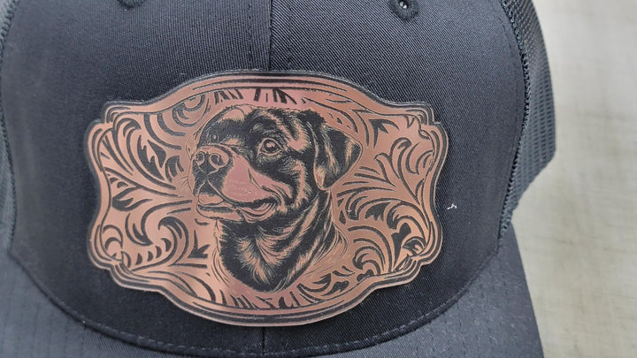 Close view of the rose-gold acrylic patch, Rottweiler head inside western floral scrollwork.