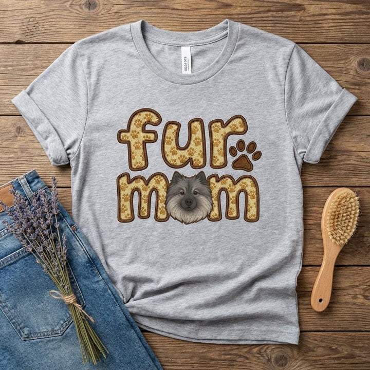 Grey tee flat on wood printed fur mom in paw-print letters with a Keeshond face and a paw.