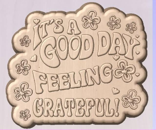 Mold cut to the shape of bubble lettering reading It's a Good Day Feeling Grateful, with flowers.