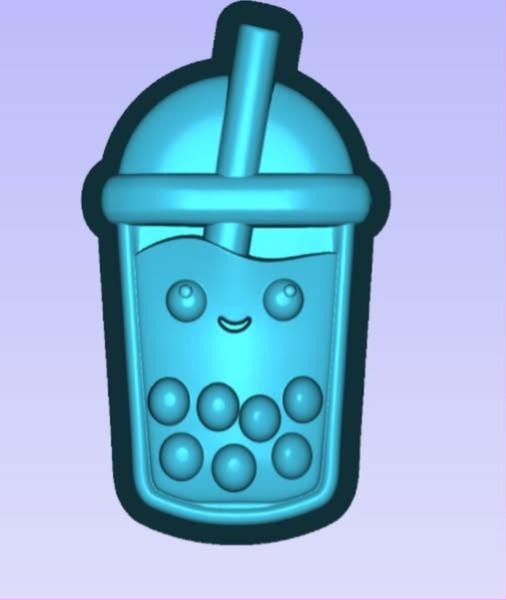 Kawaii bubble tea cup mold with a domed lid, fat straw, smiling face and tapioca pearls at the bottom.