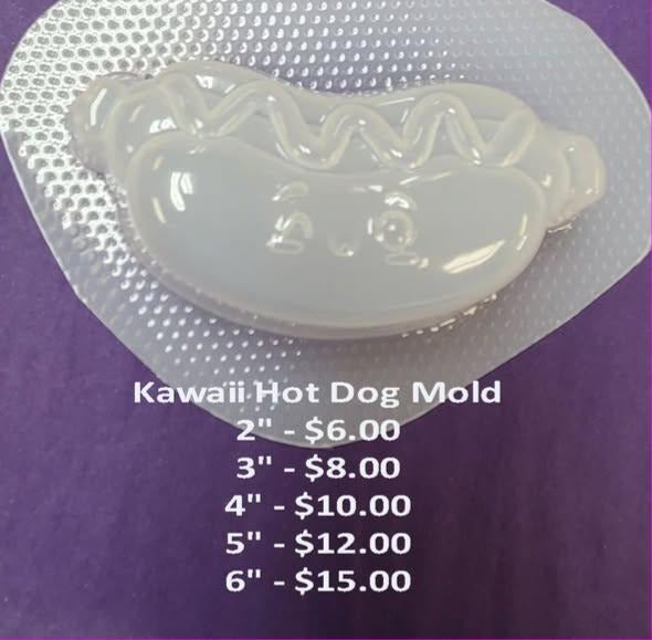 Clear plastic kawaii hot dog mold, sausage in a bun with a zigzag sauce line and a small face