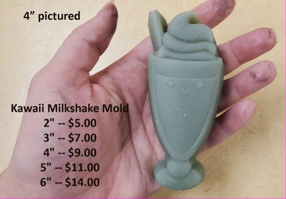 Sage cast kawaii milkshake, footed glass with whipped swirl, cherry, straw and a small face