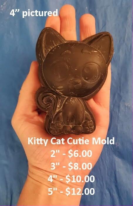 Cast mold of a chunky sitting cartoon kitten with large pointed ears and paws together