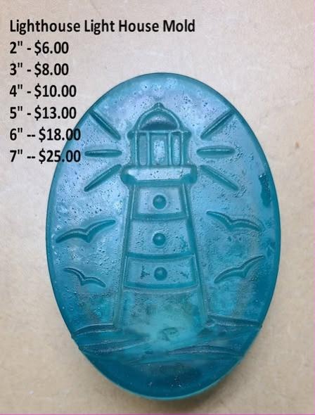 Oval lighthouse mold with railed lantern room, light rays and two gulls, cast in teal resin