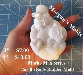 White casting of a muscular cartoon gorilla body builder wearing a small cap, held in a hand