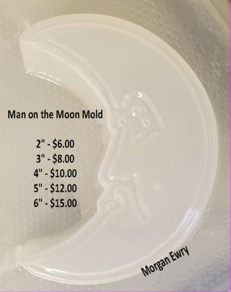 Crescent moon mold with a face in profile on the inner curve, brow, closed eye, nose and lips