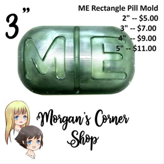 Cast mold of a rounded rectangular pill with a centre score line and the letters ME