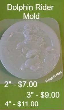 Clear round plastic mold with a mermaid riding a leaping dolphin over waves in relief