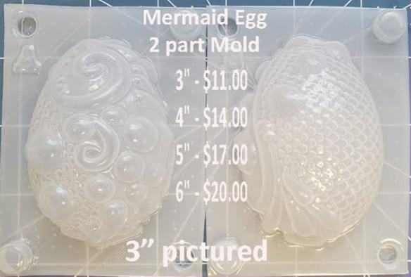 Clear two-part mermaid egg mold, a wave and bubble half beside a scaled tail half