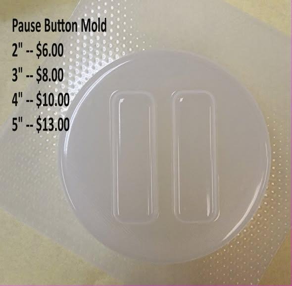 Clear plastic mold of a round disc with the two upright bars of a pause symbol in the centre.