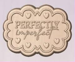 Wood-tone scalloped plaque cast reading PERFECTLY above imperfect in script, with small hearts
