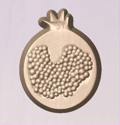 Pomegranate mold with crown on top and a heart-shaped cluster of round seeds on the face