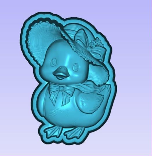 Duckling mold wearing a floppy sun hat with a flower and a bow at its neck, on a scalloped border.