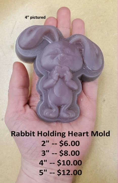 Rabbit mold sitting upright with ears raised, hugging a heart against its chest