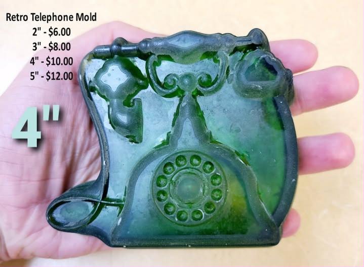 Retro rotary telephone mold with handset on the cradle, a finger-hole dial and a coiled cord.