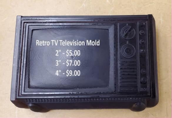 Deep brown cast retro television with a rounded screen bezel, slatted grille and two dials