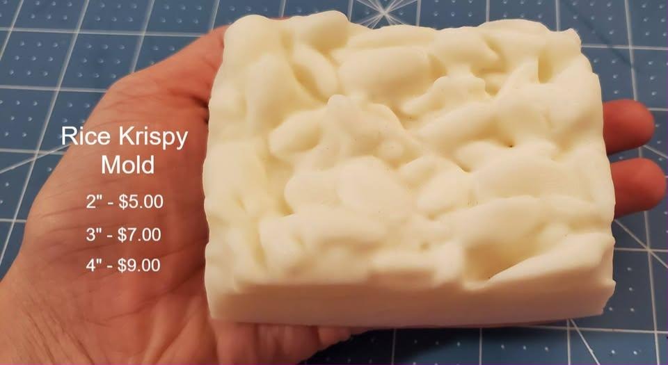 Rectangular treat bar mold with a lumpy pressed puffed cereal top face and squared ends.