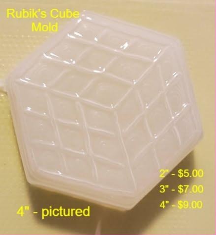 Clear plastic puzzle cube mold shown corner on with a three by three grid of squares per face.