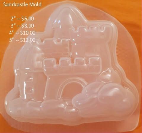 Clear plastic sandcastle mold with crenellated turrets, an arched door and a sand mound