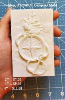 Cream nautical plaque casting with a tall ship, a compass rose and an anchor, held in a hand