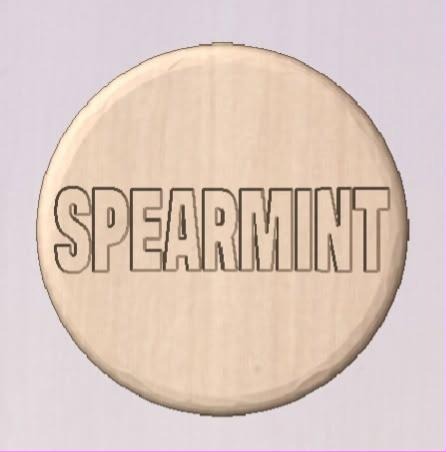 Cream round shower tablet casting with SPEARMINT in wide outlined capitals across the face