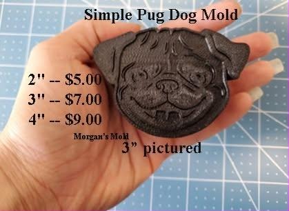 Dark brown pug face casting with folded ears, a heavily wrinkled brow and short muzzle, held in a hand