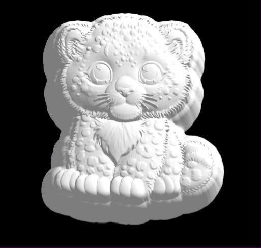 Mold of a chubby snow leopard cub sitting up with a fluffy chest ruff and curling bushy tail.