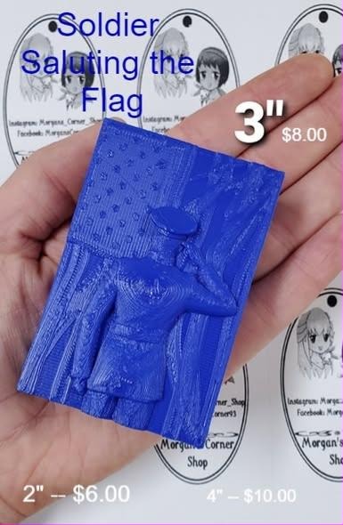 Blue cast plaque of a uniformed soldier saluting in front of a flag