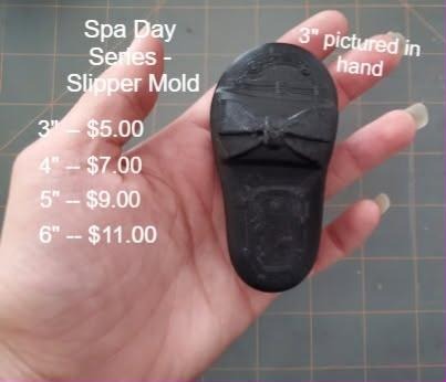 Open toe spa slipper mold with a bow across the strap and a shaped footbed