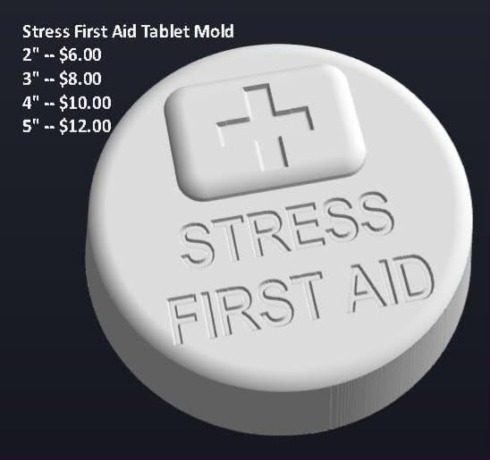 Round tablet mold with a small first aid box on the face and STRESS FIRST AID engraved beneath.