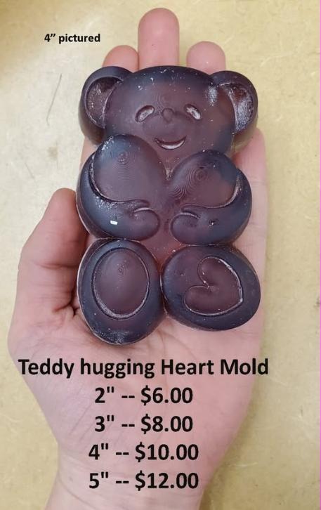 Teddy bear mold cast in deep plum, sitting and hugging a heart, filling a palm at four inches.