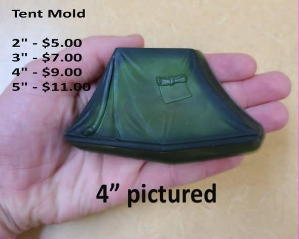 Deep green resin cast of a ridge tent with a rolled door flap, held in a palm at 4 inches.