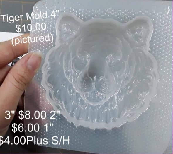 Clear plastic mold of a front-facing tiger head with a flared fur ruff and rounded ears.