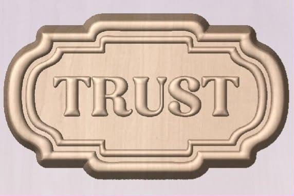 Rectangular plaque mold with an ornate bracketed border and TRUST in serif capitals.