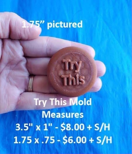 Copper brown round token mold held in a hand, lettered Try This in two lines.