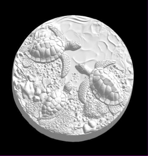 White cast round disc mold with three sea turtles crossing a pebbled reef floor.
