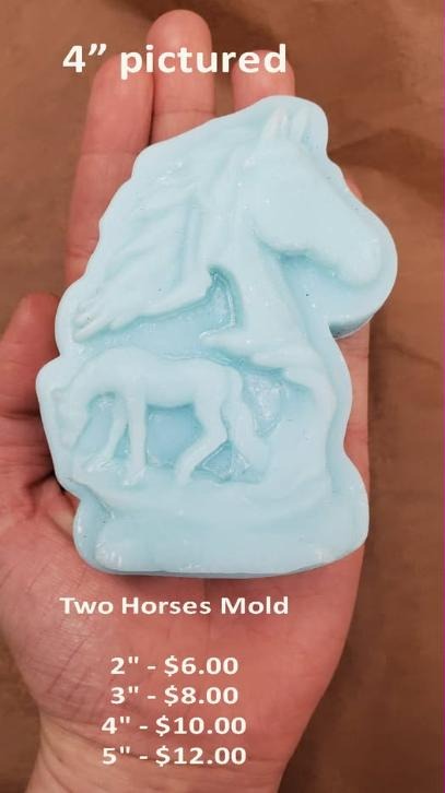 Pale blue cast of a horse's head in profile above a small standing foal, held in a palm.