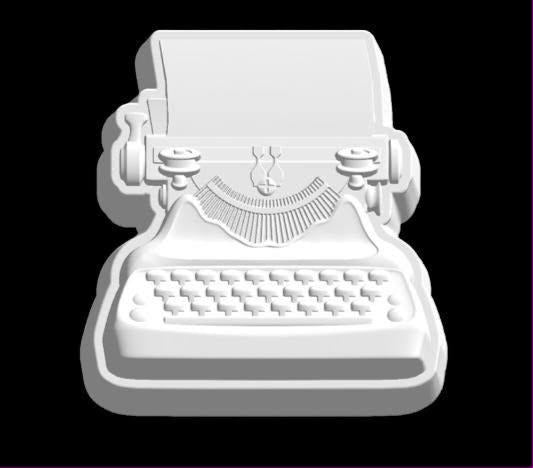 Vintage typewriter mold with paper in the platen, spool knobs and staggered rows of round keys.