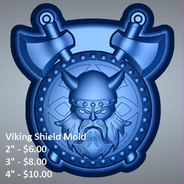 Round Viking shield mold with a horned-helmet warrior face and two crossed axes behind.