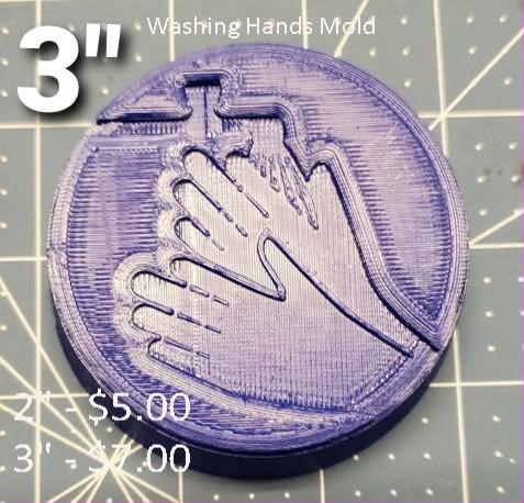 Violet round disc mold engraved with two hands washing under a running tap.
