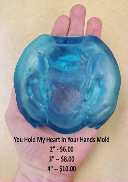 Translucent blue cast of two cupped hands cradling a heart, held in a palm.